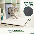 A grey tabby cat stepping out of a fabric cube pet house onto a white fluffy mat, accompanied by a circular zoom-in feature showing the non-slip dotted bottom and text reading "NON-SLIP BOTTOM".