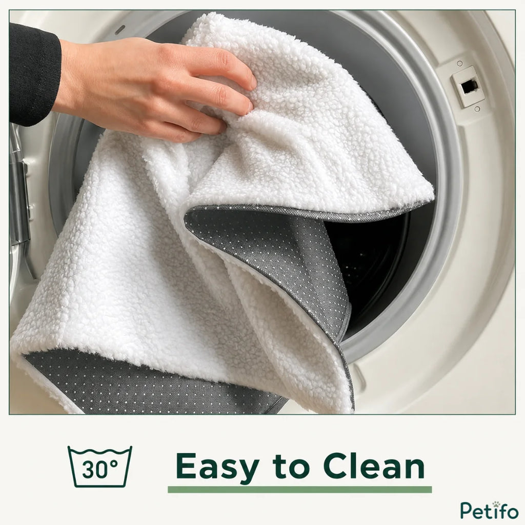 A hand placing the white and grey pet mat into a washing machine drum, with a "30°" washing icon and the text "Easy to Clean".