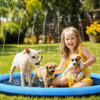 Young girl smiling and holding a puppy while other dogs play in a backyard water sprinkler pool.